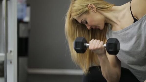 The girl did a dumbbell exercise